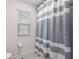 Bathroom with striped shower curtain and window at 5645 Camilla St, St Cloud, FL 34771