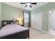 Cozy bedroom with carpet, closet, and soft green walls offers a relaxing retreat at 5645 Camilla St, St Cloud, FL 34771