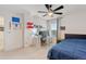 Cozy bedroom with carpet, a large window, and a ceiling fan at 5645 Camilla St, St Cloud, FL 34771