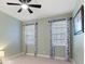 Comfortable bedroom featuring tile flooring, neutral walls, and a ceiling fan at 5645 Camilla St, St Cloud, FL 34771