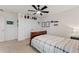 Cozy bedroom with a ceiling fan, neutral decor, and ample closet space at 5645 Camilla St, St Cloud, FL 34771