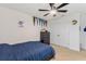 Neutral bedroom with a ceiling fan, double closet, and carpet flooring at 5645 Camilla St, St Cloud, FL 34771