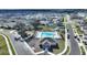 An aerial view of a community pool with a spacious layout, lounge chairs, and verdant landscaping; perfect for recreation at 5645 Camilla St, St Cloud, FL 34771