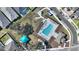 A scenic aerial view of a community pool, picnic area, and verdant landscape amidst a community of single Gathering homes at 5645 Camilla St, St Cloud, FL 34771