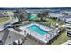 Aerial view showcasing a large community pool with lounge chairs, pergola, and a covered picnic area for outdoor enjoyment at 5645 Camilla St, St Cloud, FL 34771