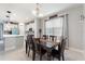 Dining area with views of the kitchen and backyard through large windows at 5645 Camilla St, St Cloud, FL 34771