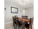 Dining room with dark wood table and seating for six beneath decorative lighting at 5645 Camilla St, St Cloud, FL 34771