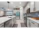 Well-lit kitchen features white cabinets, stainless steel appliances, and a central island at 5645 Camilla St, St Cloud, FL 34771