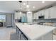Spacious kitchen features white cabinets, a large center island, and stainless steel appliances at 5645 Camilla St, St Cloud, FL 34771