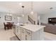 Bright kitchen featuring a center island, stainless steel appliances, and easy access to the living room at 5645 Camilla St, St Cloud, FL 34771
