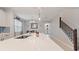 Open kitchen with large island, stainless steel sink, and easy access to stairs and dining room at 5645 Camilla St, St Cloud, FL 34771