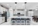 Modern kitchen boasts a large island with seating, white cabinetry, and stainless steel appliances at 5645 Camilla St, St Cloud, FL 34771