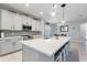 Bright kitchen with white cabinets, quartz countertops, a large center island, and tiled backsplash at 5645 Camilla St, St Cloud, FL 34771