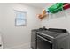 Laundry room with gray washer and dryer, shelving, and window at 5645 Camilla St, St Cloud, FL 34771