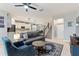 Comfortable living room features tile flooring, a ceiling fan, and views to the kitchen and dining room at 5645 Camilla St, St Cloud, FL 34771