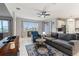 Bright living room with views through a large window, comfortable seating, and tile floors at 5645 Camilla St, St Cloud, FL 34771