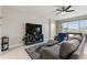 Comfortable living room features tile flooring, a ceiling fan, and natural light from the window at 5645 Camilla St, St Cloud, FL 34771