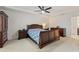 Main bedroom with carpet, tray ceilings, ceiling fan, and wood furniture at 5645 Camilla St, St Cloud, FL 34771