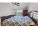 Main bedroom with carpet, tray ceilings, ceiling fan, and window at 5645 Camilla St, St Cloud, FL 34771