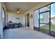 Relaxing screened patio with ceiling fan, grill, seating, and outdoor string lights at 5645 Camilla St, St Cloud, FL 34771