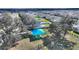 Aerial view showcasing a picnic area with a blue canopy and benches surrounded by mature trees and green space at 5645 Camilla St, St Cloud, FL 34771