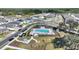 Aerial view showcasing a community pool with lounge chairs, a shaded pavilion, and manicured landscaping for relaxation at 5645 Camilla St, St Cloud, FL 34771