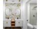 Stunning remodeled bathroom with dual vanities, modern lighting, designer tile, and gold hardware at 607 Dunblane Dr, Winter Park, FL 32792
