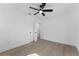 Spacious bedroom with new flooring and ceiling fan, featuring a doorway with black hardware leading to a closet at 607 Dunblane Dr, Winter Park, FL 32792