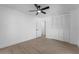 A bright bedroom features a ceiling fan, wood-look floors, closet and fresh white paint at 607 Dunblane Dr, Winter Park, FL 32792