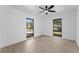 A bright bedroom with fresh paint, wood-look floors and two windows overlooks the front yard at 607 Dunblane Dr, Winter Park, FL 32792