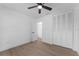 Bright bedroom featuring a ceiling fan and multiple closets with doors at 607 Dunblane Dr, Winter Park, FL 32792
