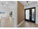Bright foyer showcasing a modern wood slat accent wall, leading into an open-concept kitchen at 607 Dunblane Dr, Winter Park, FL 32792