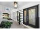 Inviting front entrance featuring a decorative glass door, contemporary lighting, and manicured landscaping at 607 Dunblane Dr, Winter Park, FL 32792