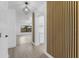 Hallway view to bright living room and kitchen; modern decorative wood accent wall at 607 Dunblane Dr, Winter Park, FL 32792