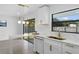 A pristine kitchen featuring quartz countertops, stainless steel appliances, and an eat in island with pendant lighting at 607 Dunblane Dr, Winter Park, FL 32792