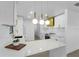 Modern kitchen boasts white cabinets with gold accents, marble countertops and stainless appliances at 607 Dunblane Dr, Winter Park, FL 32792