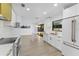 Modern kitchen boasts an open layout with quartz countertops, eat-in island, and stainless steel appliances at 607 Dunblane Dr, Winter Park, FL 32792