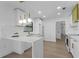 Modern kitchen boasts white cabinets with gold accents, marble countertops and stainless appliances at 607 Dunblane Dr, Winter Park, FL 32792