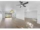 Bright living room with light-colored wood floors and kitchen view at 607 Dunblane Dr, Winter Park, FL 32792