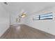 Bright living room with light-colored wood floors, large windows, and modern light fixture at 607 Dunblane Dr, Winter Park, FL 32792
