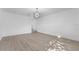 Bright living room with light-colored wood floors, white walls, and contemporary light fixture at 607 Dunblane Dr, Winter Park, FL 32792