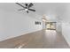 Bright living room with light-colored wood floors, contemporary light fixtures, and ceiling fan at 607 Dunblane Dr, Winter Park, FL 32792