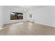 Bright living room with light-colored wood floors, white walls, and contemporary light fixture at 607 Dunblane Dr, Winter Park, FL 32792