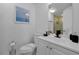 Clean bathroom with a white toilet and vanity with black hardware, plus a shower, creates a tidy and functional space at 6165 Carrier Dr # 3701, Orlando, FL 32819