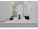 Well-lit bathroom with a white vanity, black faucet, and coordinated accessories, offering a fresh and modern feel at 6165 Carrier Dr # 3701, Orlando, FL 32819