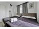 A serene bedroom with two beds, comfortable bedding, and a glimpse of the en-suite bathroom at 6165 Carrier Dr # 3701, Orlando, FL 32819