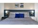A comfortable bed is flanked by modern nightstands and tasteful artwork at 6165 Carrier Dr # 3701, Orlando, FL 32819