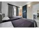 This is a lovely bedroom with two beds, gray bedding, and wall-mounted TV at 6165 Carrier Dr # 3701, Orlando, FL 32819