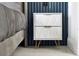 The bedroom has a contemporary bedside table with stylish white storage drawers at 6165 Carrier Dr # 3701, Orlando, FL 32819