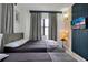 A cozy bedroom featuring two beds, stylish wall decor, and an abundance of natural light at 6165 Carrier Dr # 3701, Orlando, FL 32819